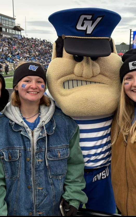 Woman smiling at camera with louie the laker